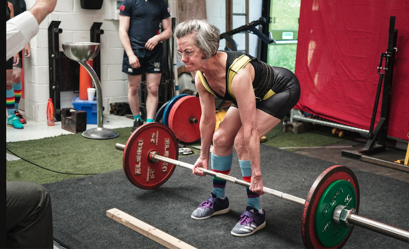 old lady doing dead lifts